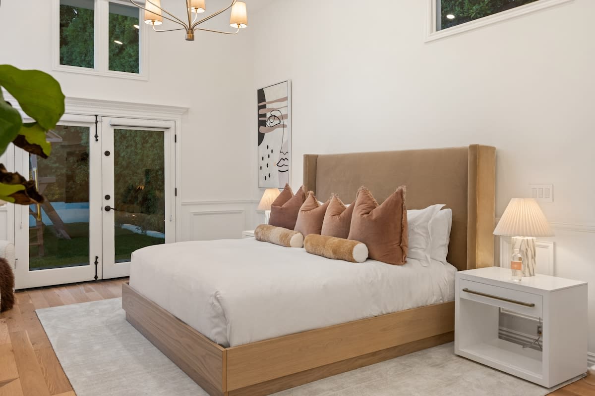 Extend your relaxation to the outdoors with French doors in Bedroom 1, seamlessly connecting your haven to the serene backyard.