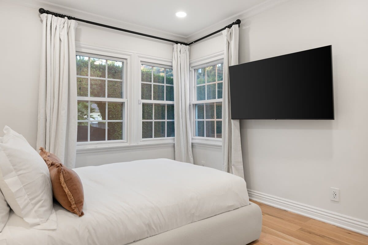 Elevate your experience with a Large Smart TV in Bedroom 2, providing modern entertainment for a delightful stay.