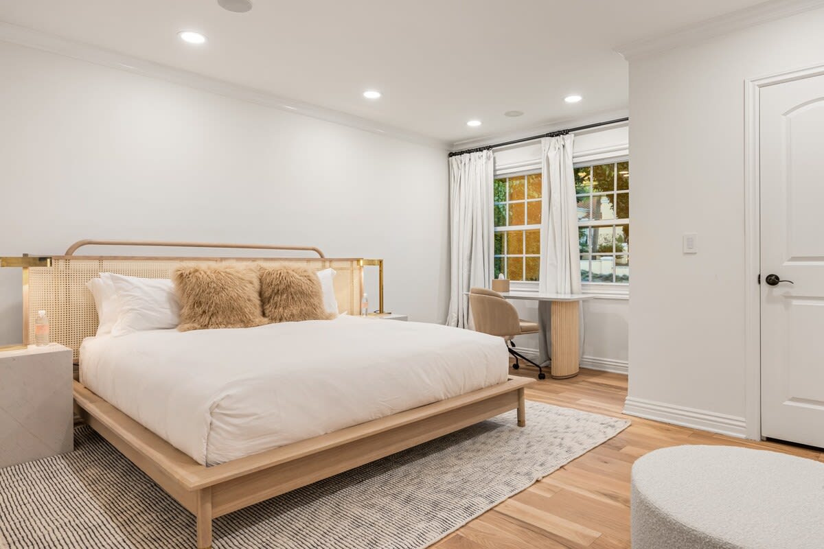 Experience a spacious retreat with a large bed and desk space, offering both comfort and functionality.