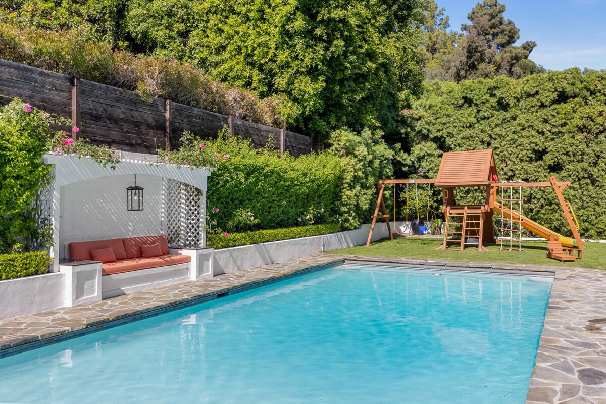 Experience a playful paradise with a jungle gym and pool, offering the perfect blend of outdoor fun and refreshing relaxation.