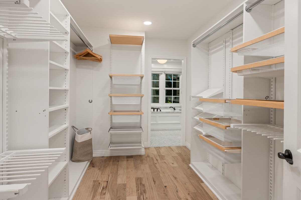 Step into a walk-in closet exuding chic elegance, providing a stylish haven for your wardrobe.