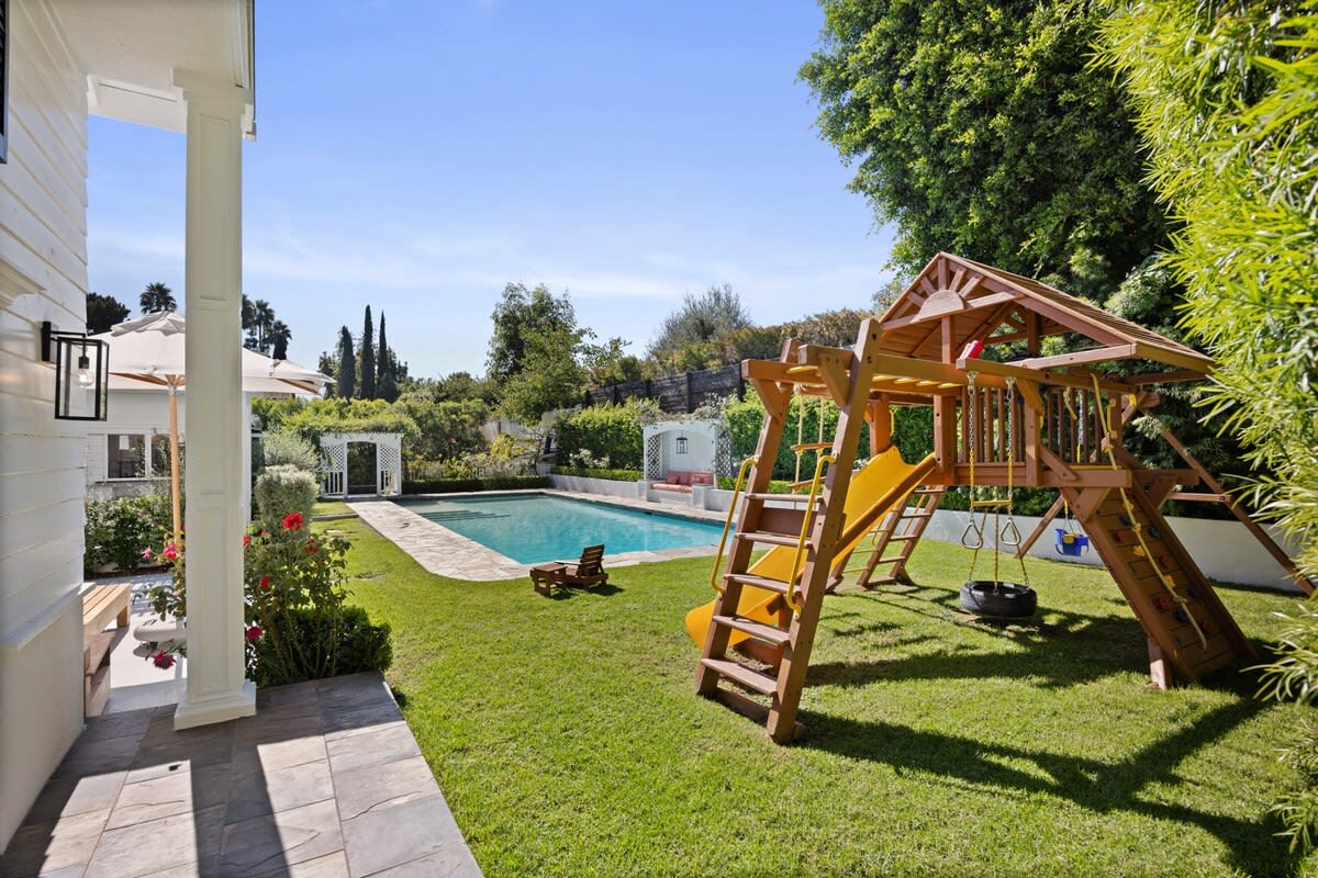 Explore outdoor fun at the backyard jungle gym – slide and swings for family joy.