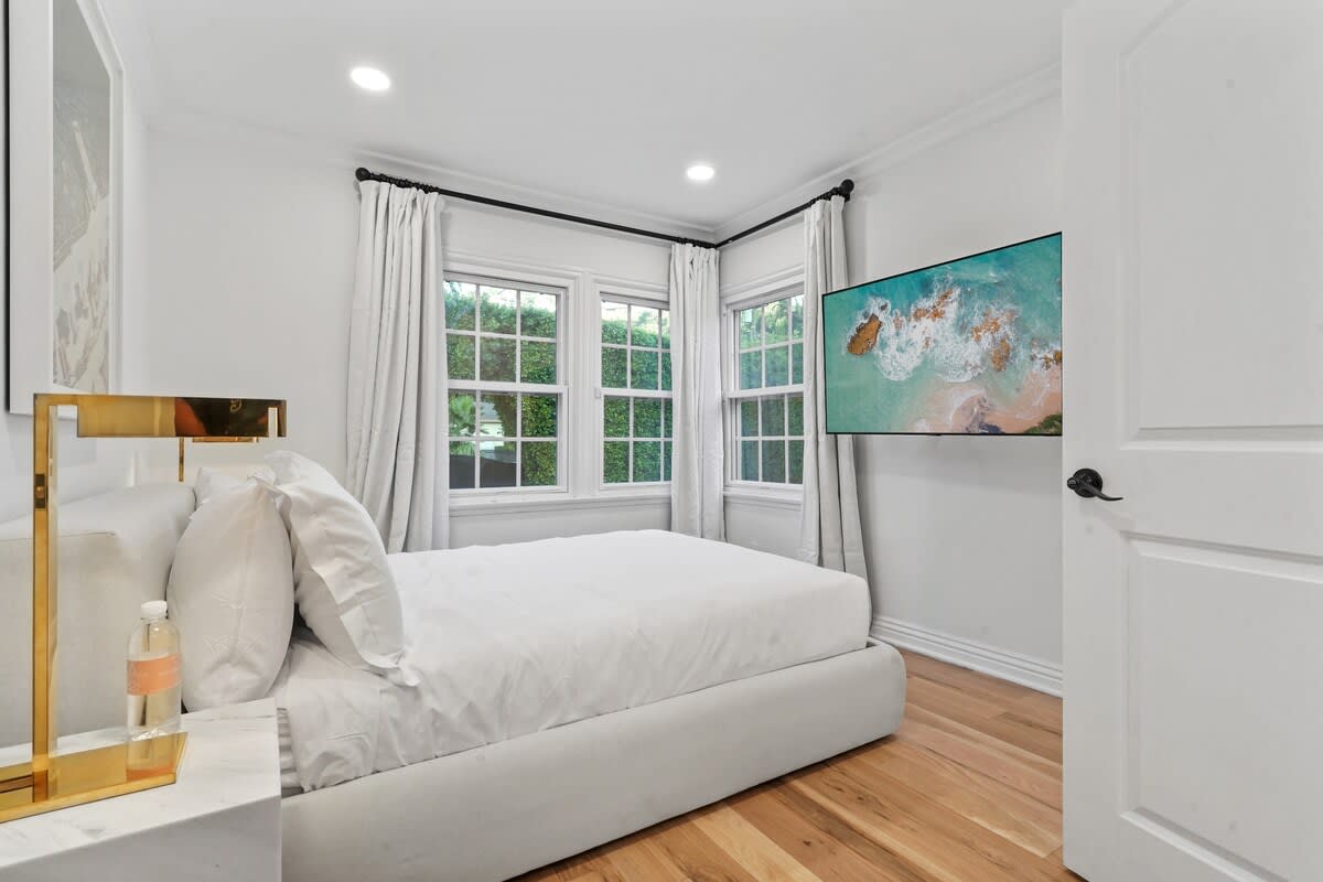 Rest and relaxation in the 3rd Guest Bedroom with a queen-size bed and a large Smart TV.