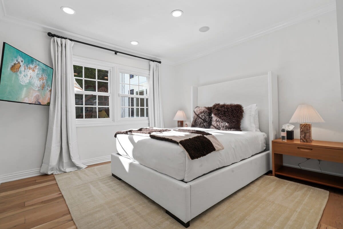 Discover comfort and entertainment in the 4th Bedroom, featuring a full-sized bed, a large Smart TV, and a private ensuite bath with a refreshing shower.