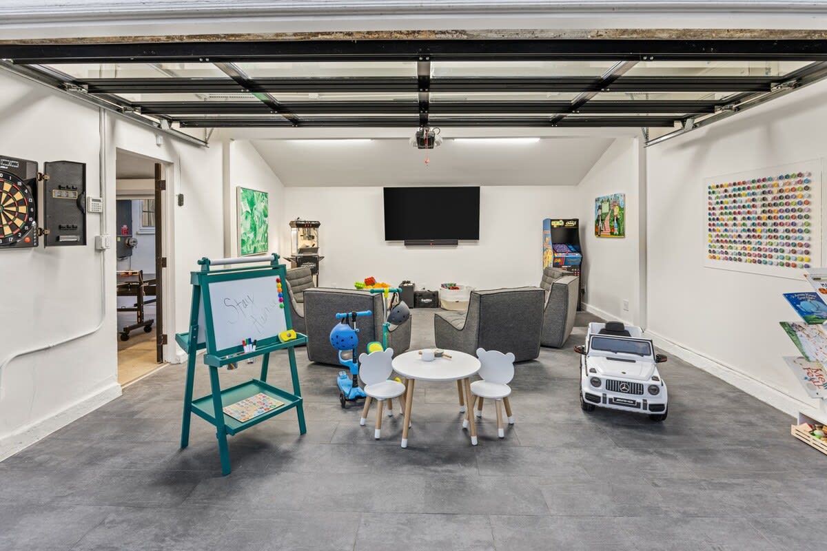 Immerse yourself in the endless fun of the Game Room, a playful haven equipped with modular seating, kids' toys, and a delightful children's table.