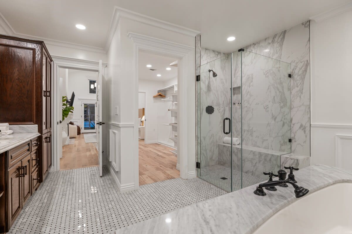 Embrace luxury in the ensuite bathroom, a private haven with a chic glass walk-in shower.