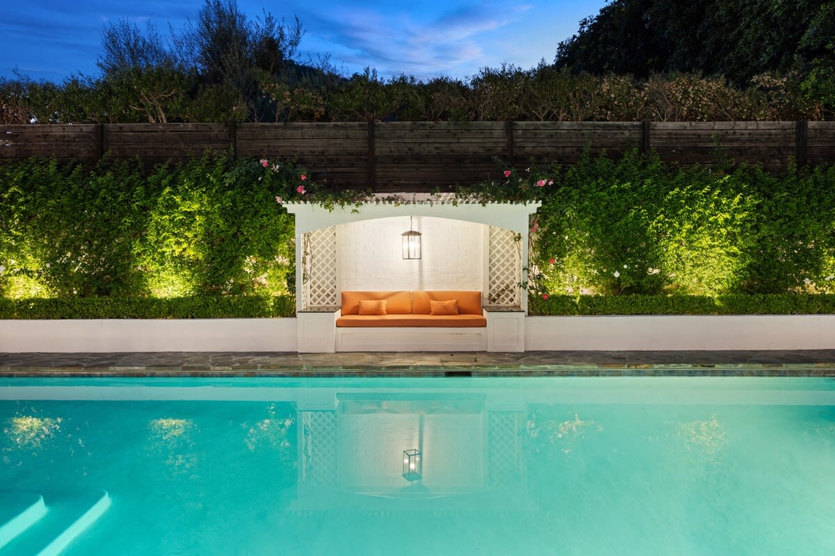 Enjoy the charm of an evening by the pool—an inviting feature that makes nights at home relaxing and delightful.