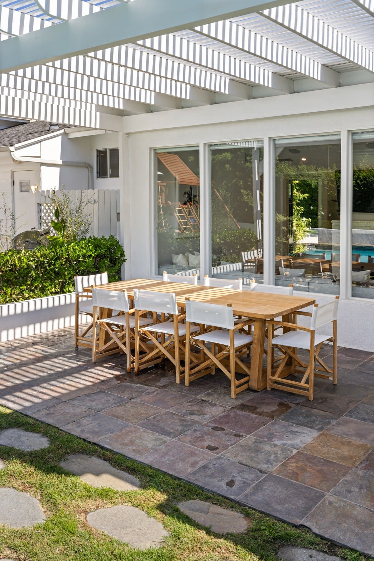 Wooden table on the patio, seating 8—an alfresco haven for delightful outdoor gatherings.