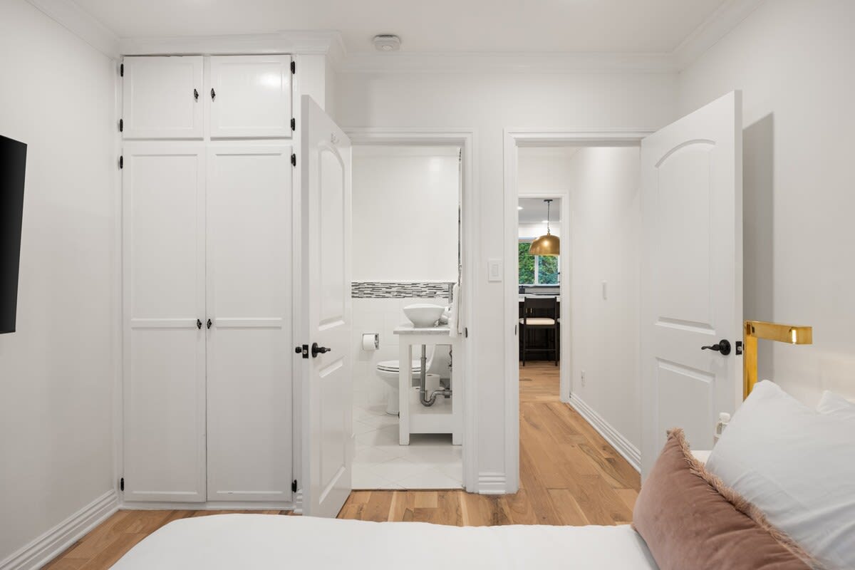 Discover an intimate escape in this ensuite bedroom, where luxury and comfort seamlessly intertwine.