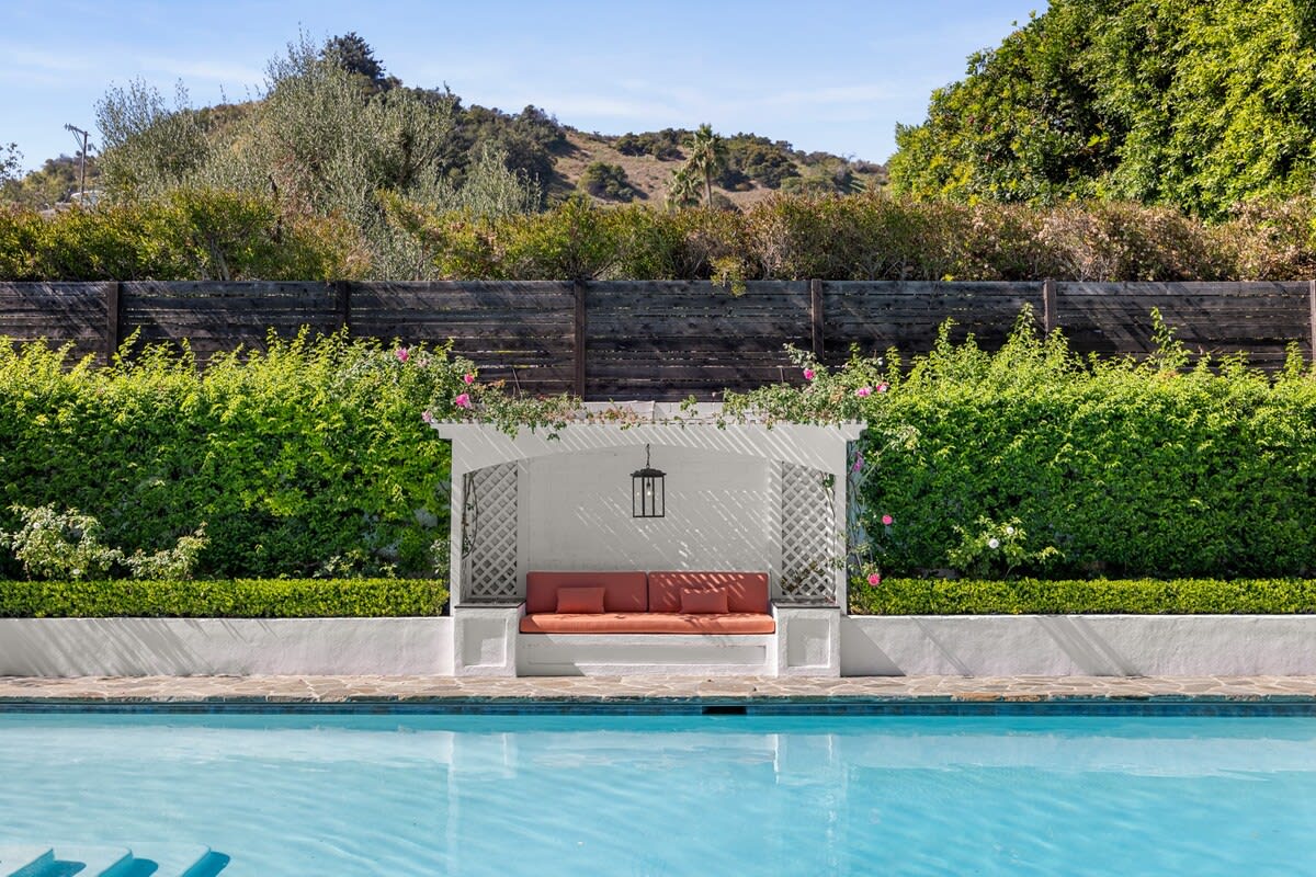 Daytime allure with poolside cabana and lush greenery—an exclusive retreat for ultimate relaxation.