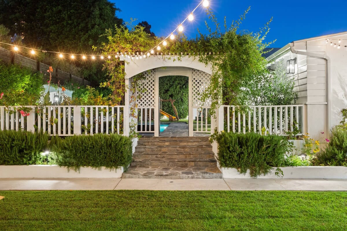 String lights weave a mesmerizing glow, transforming the garden into a magical sanctuary under the starlit night sky.