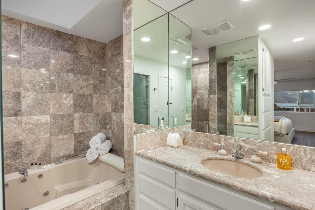 Experience opulence in the marble-tiled bathroom, boasting, fresh towels and premium amenities.