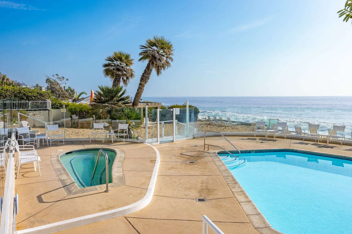 Indulge in poolside bliss with the hot tub, set on a timer for your convenience, offering relaxation with a touch of coastal elegance.