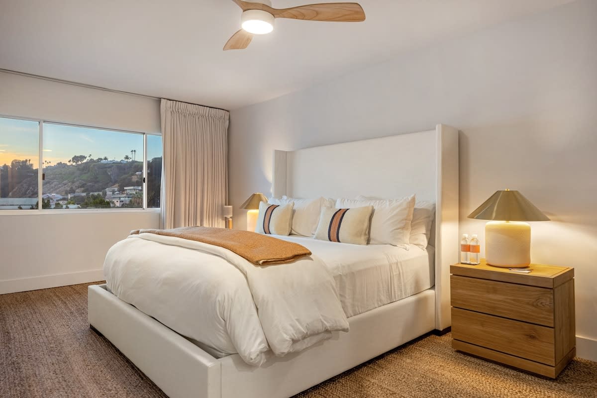 Wake to golden light and ocean views in the guest bedroom retreat.