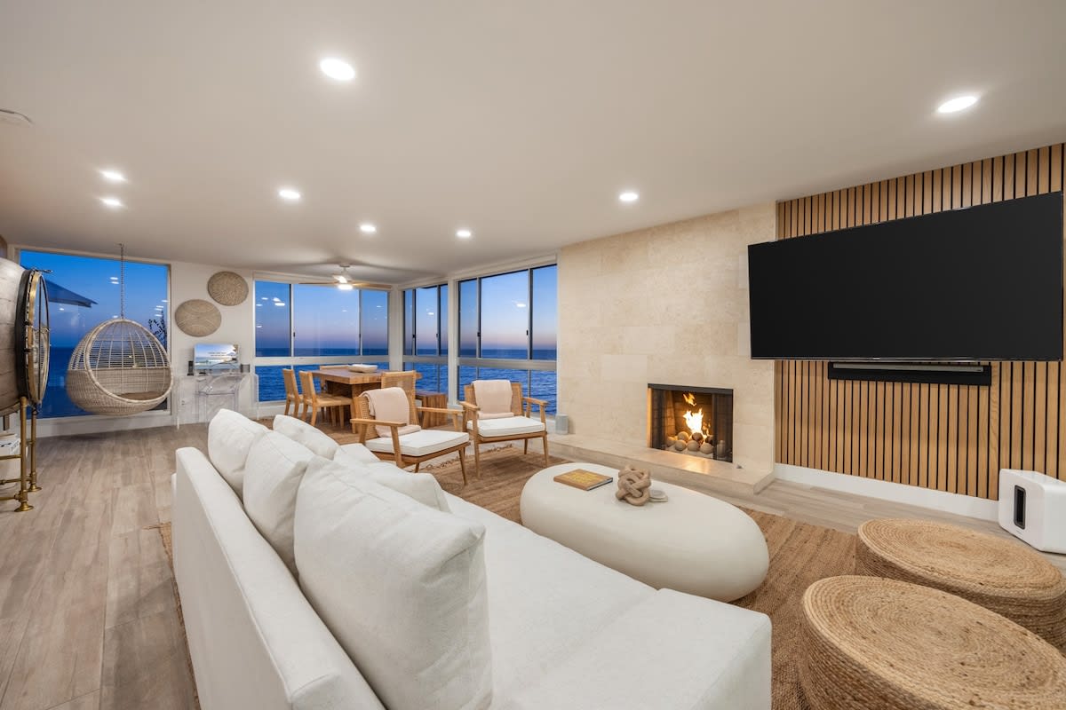 Evenings glow with soft firelight, boucle textures, and a horizon that never fades.