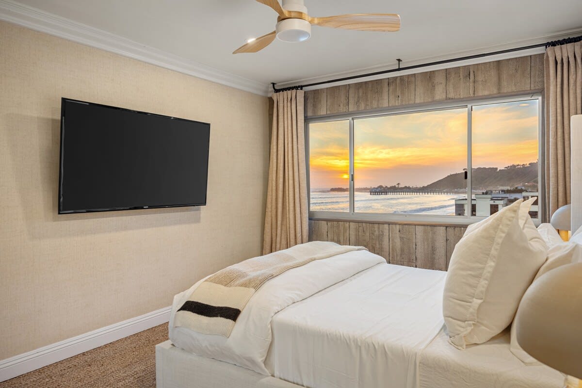 Enjoy the sunset from the comfort of the bedroom, where coastal views meet relaxation.