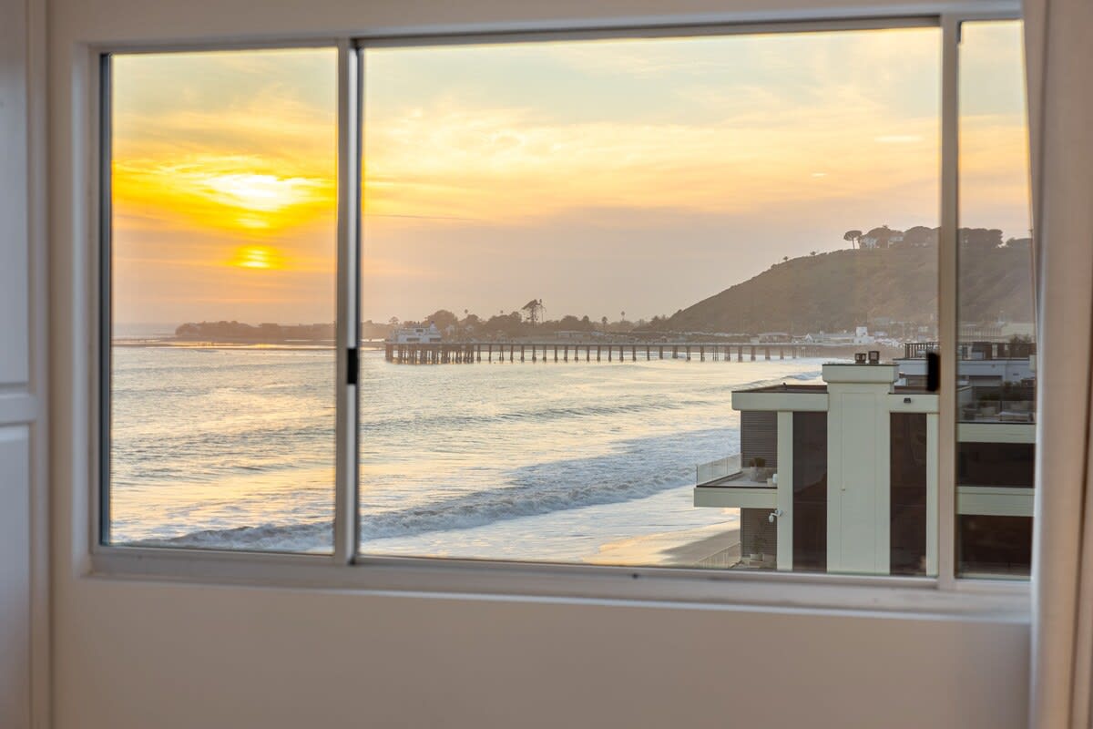 Wind down in the bedroom, where sunset hues set the mood for a peaceful evening.
