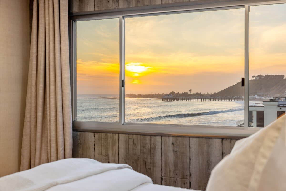 Wind down in the bedroom, where sunset hues set the mood for a peaceful evening.