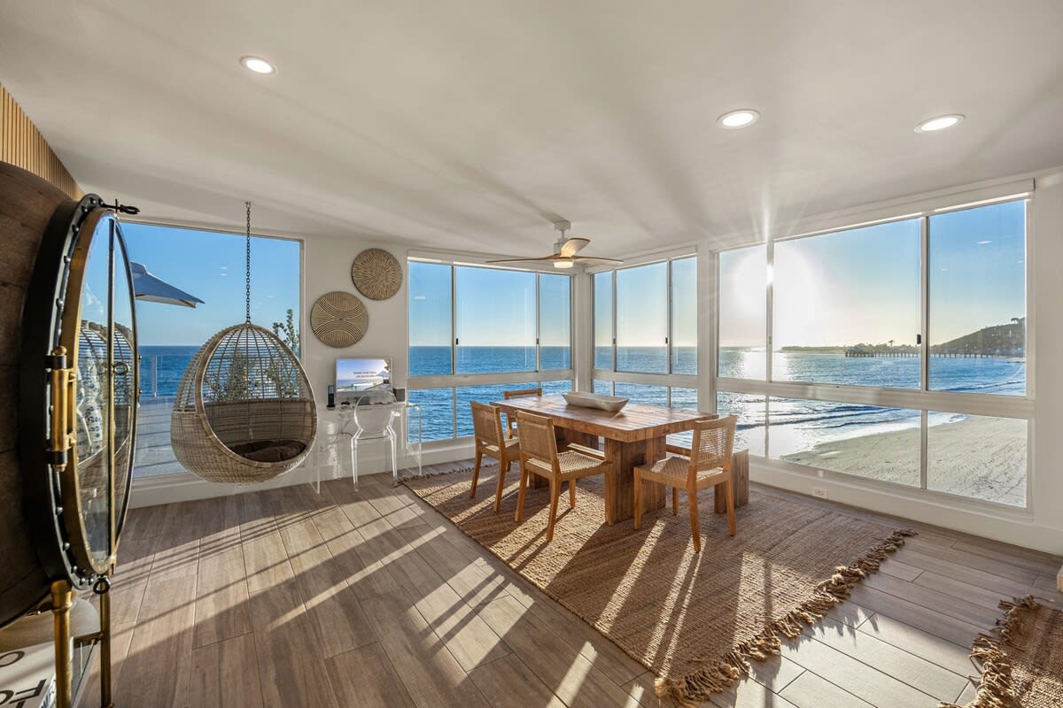 Breakfast with the Pacific, framed by floor-to-ceiling glass.