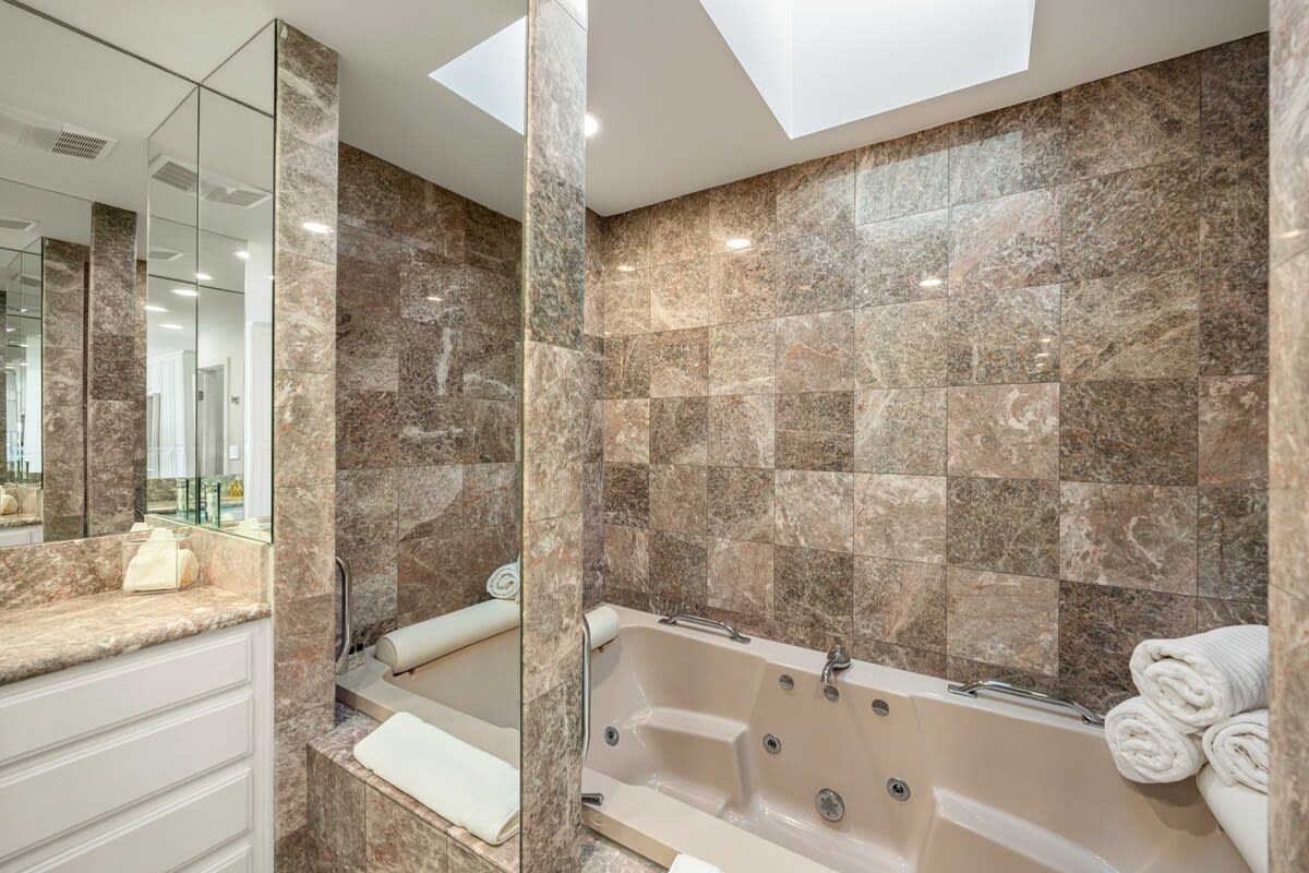 Soak in privacy and peace with spa jets and mirrored elegance.