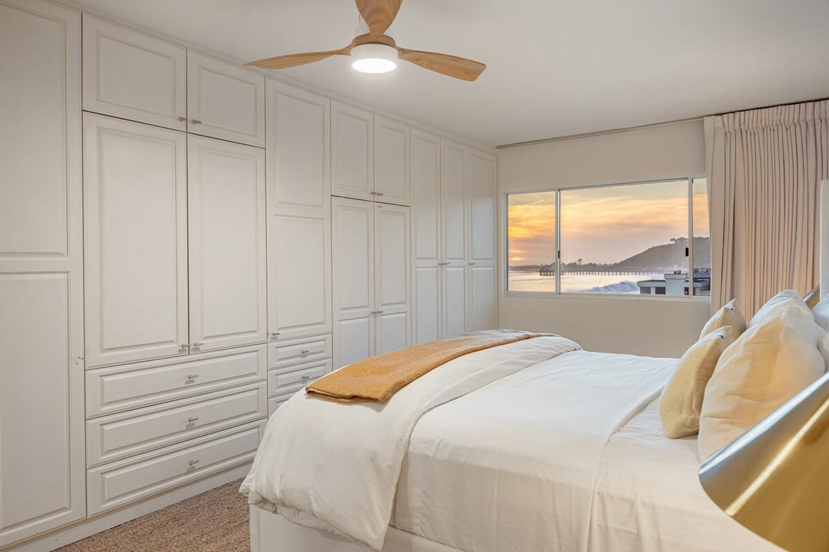 Enjoy the sunset from the comfort of the bedroom, where coastal views meet relaxation.