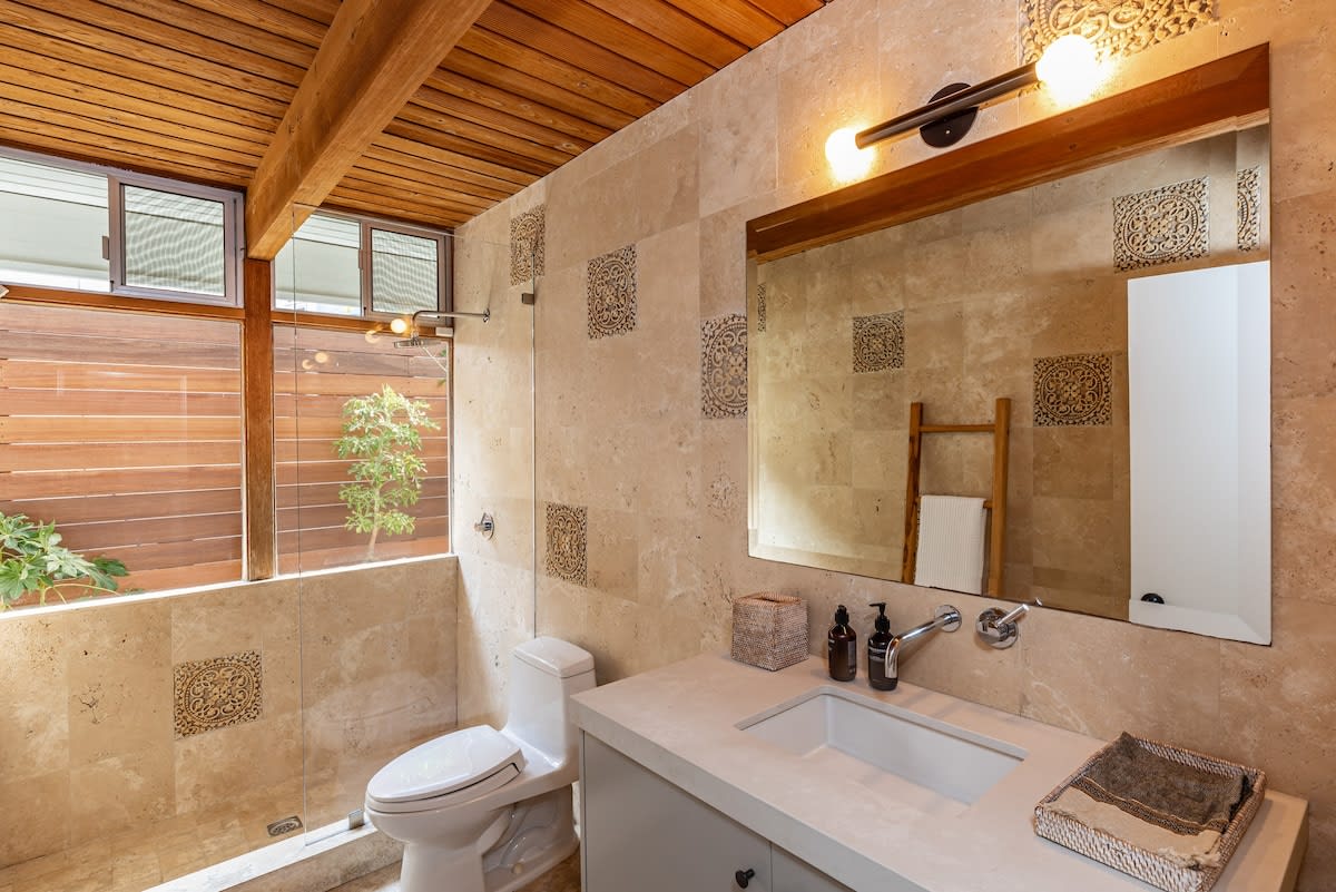 Indulge in the bathroom's walk-in glass shower, offering both style and functionality for a refreshing and rejuvenating experience.