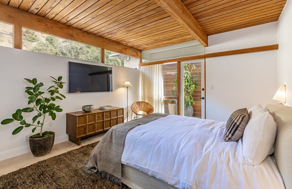 Discover calmness in the comfortable Bedroom, boasting a king-size bed, blackout window treatments, and a smart TV with a Sonos Sound Bar.