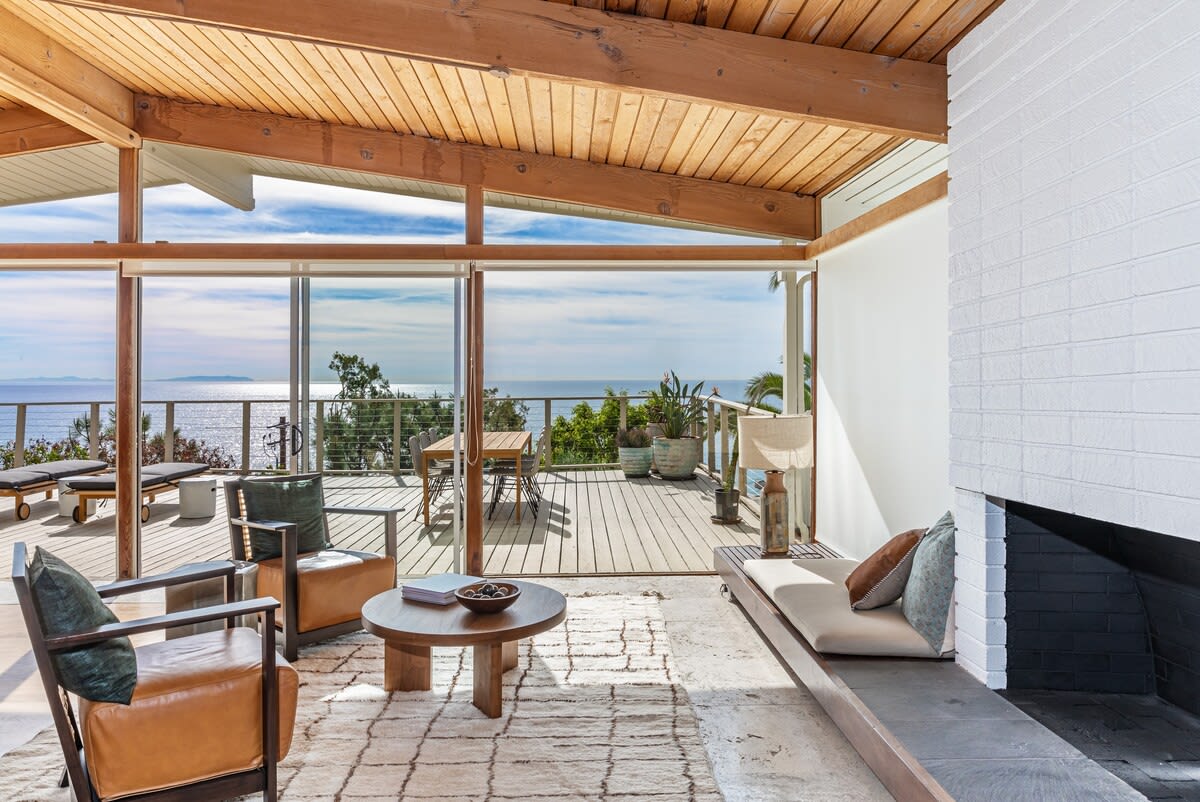 The living room's gas fireplace and comfy boucle sectional invite cozy moments by the hearth.