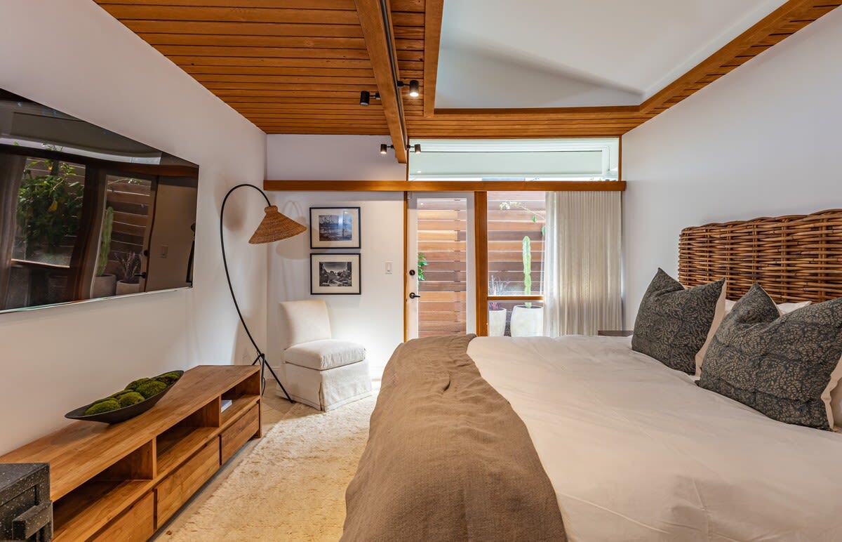 Discover calmness in the comfortable Bedroom, boasting a king-size bed, blackout window treatments, and a smart TV with a Sonos Sound Bar.