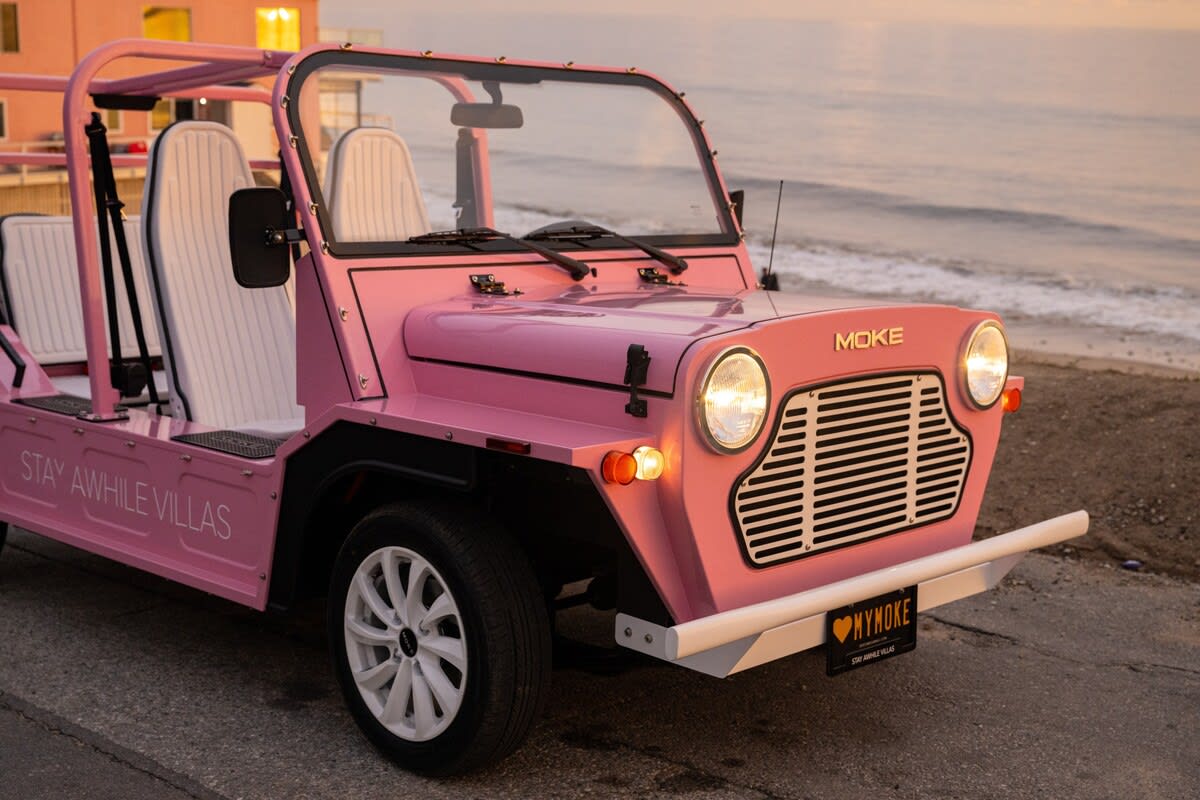 The Beach Pink Moke, a stylish coastal chariot, awaits to add a dash of flair to your Malibu adventure.