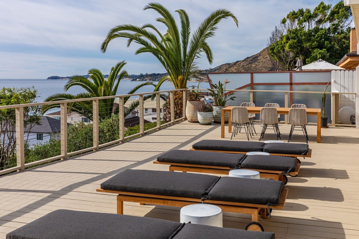 Alfresco elegance on the expansive deck invites you to relish Malibu sunsets with commanding Pacific views.