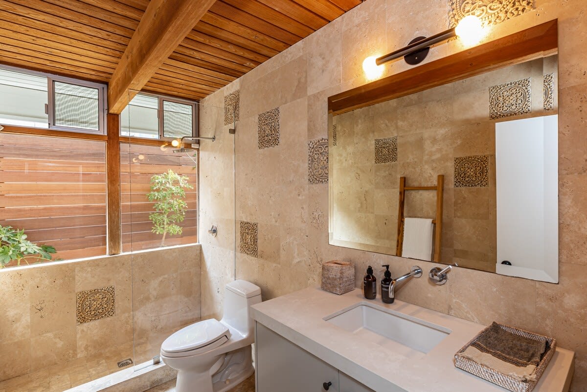 Immerse yourself in the sleek design of the walk-in glass shower, a modern retreat within the elegant confines of the bathroom.