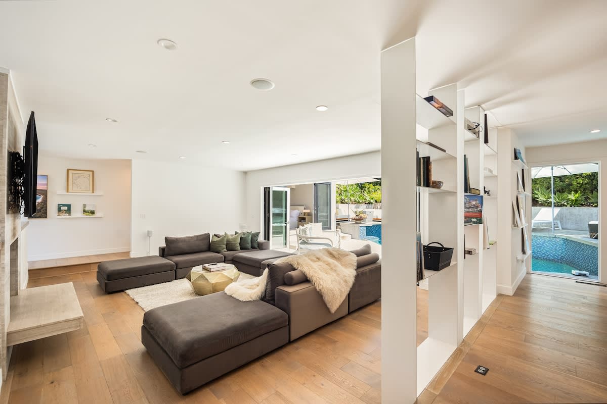 From the living area's sofa, catch your favorite shows on TV with direct access to the pool just steps away.