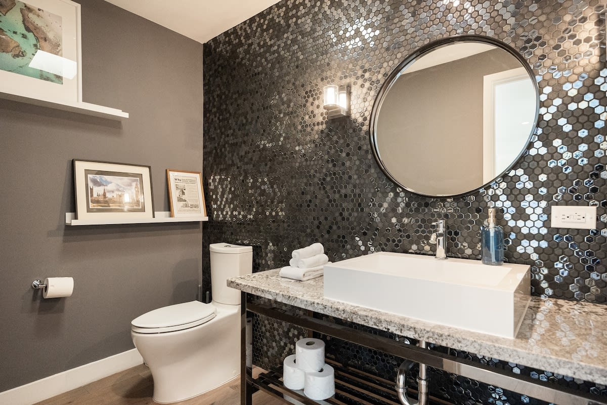 Refresh in the elegant half bathroom, featuring modern amenities and sophisticated decor.