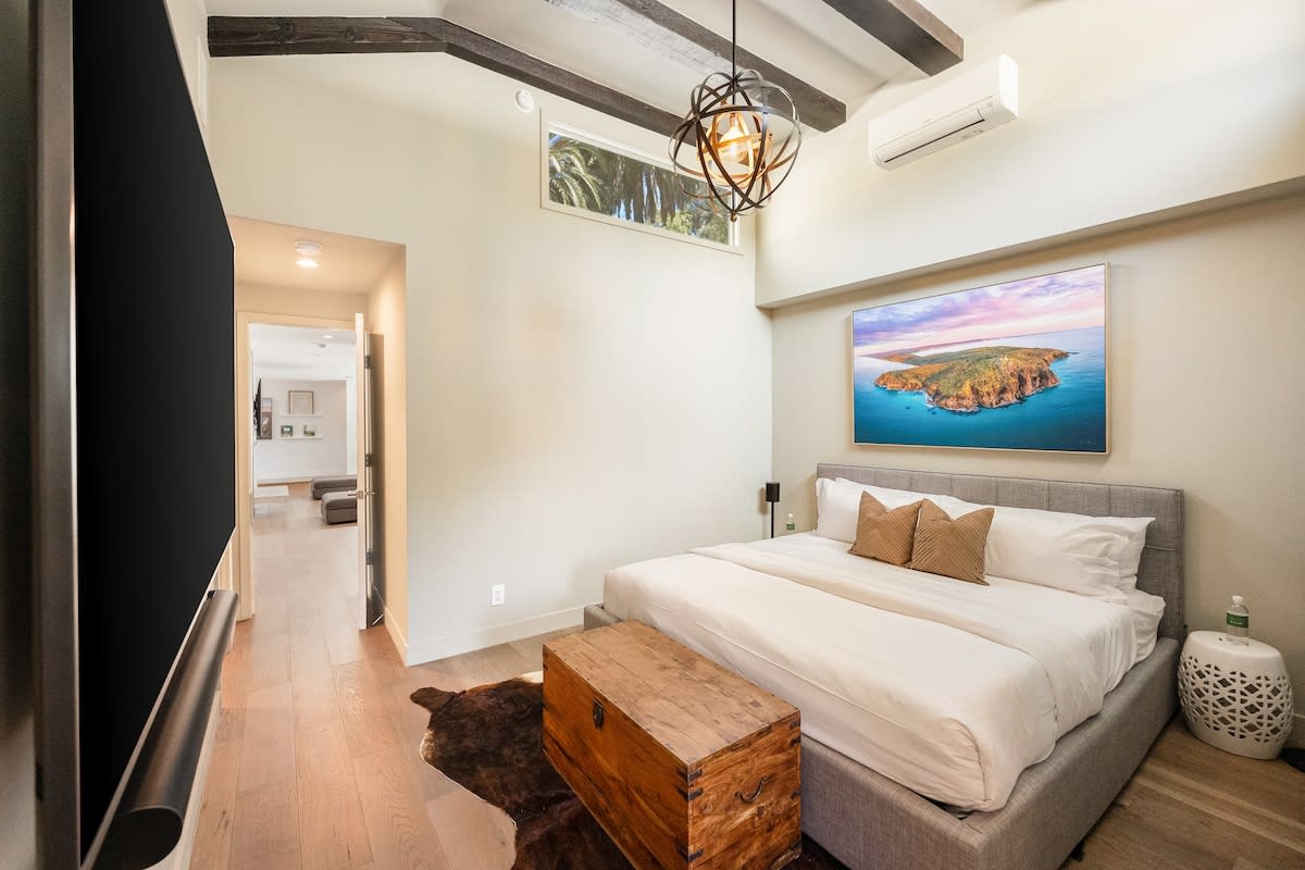 Boasting tall ceilings, the bedroom combines comfort and style for a truly luxurious retreat.