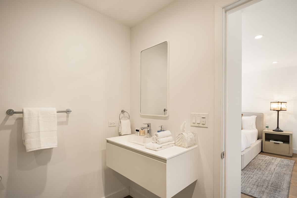 Refresh in the elegant ensuite bathroom, featuring modern amenities and sophisticated decor.