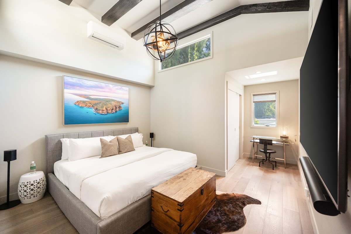 Boasting tall ceilings, the bedroom combines comfort and style for a truly luxurious retreat.