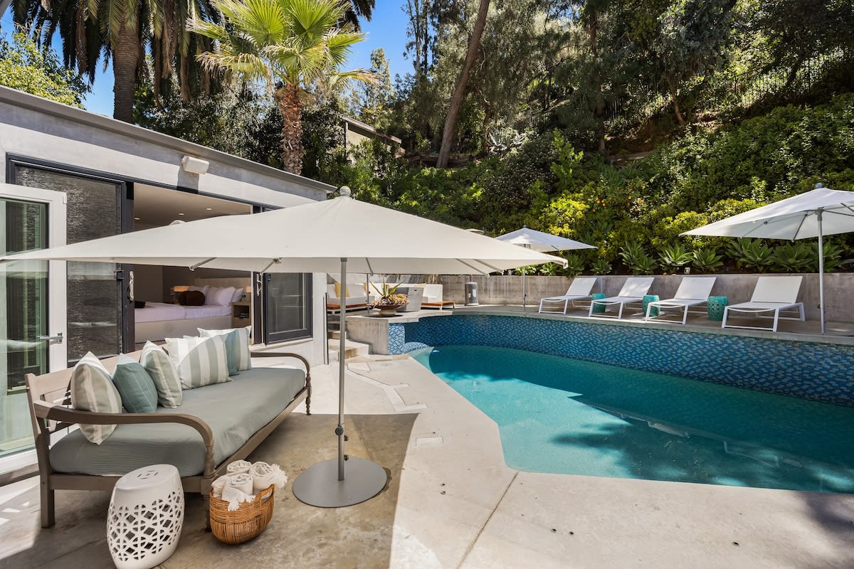 Surrounded by lush landscaping, the pool offers a serene retreat from the bustling city life.