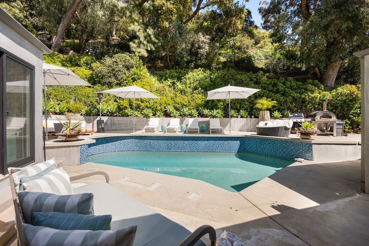 Lush green surroundings provide a picturesque backdrop to the outdoor retreat.