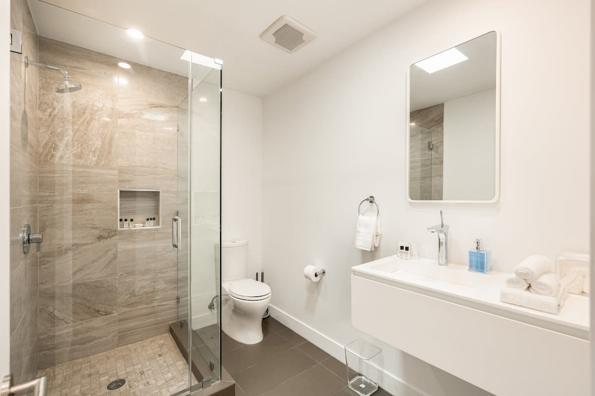Indulge in luxury in the beautifully appointed bathroom, complete with a shower and all the essential amenities for a comfortable stay.