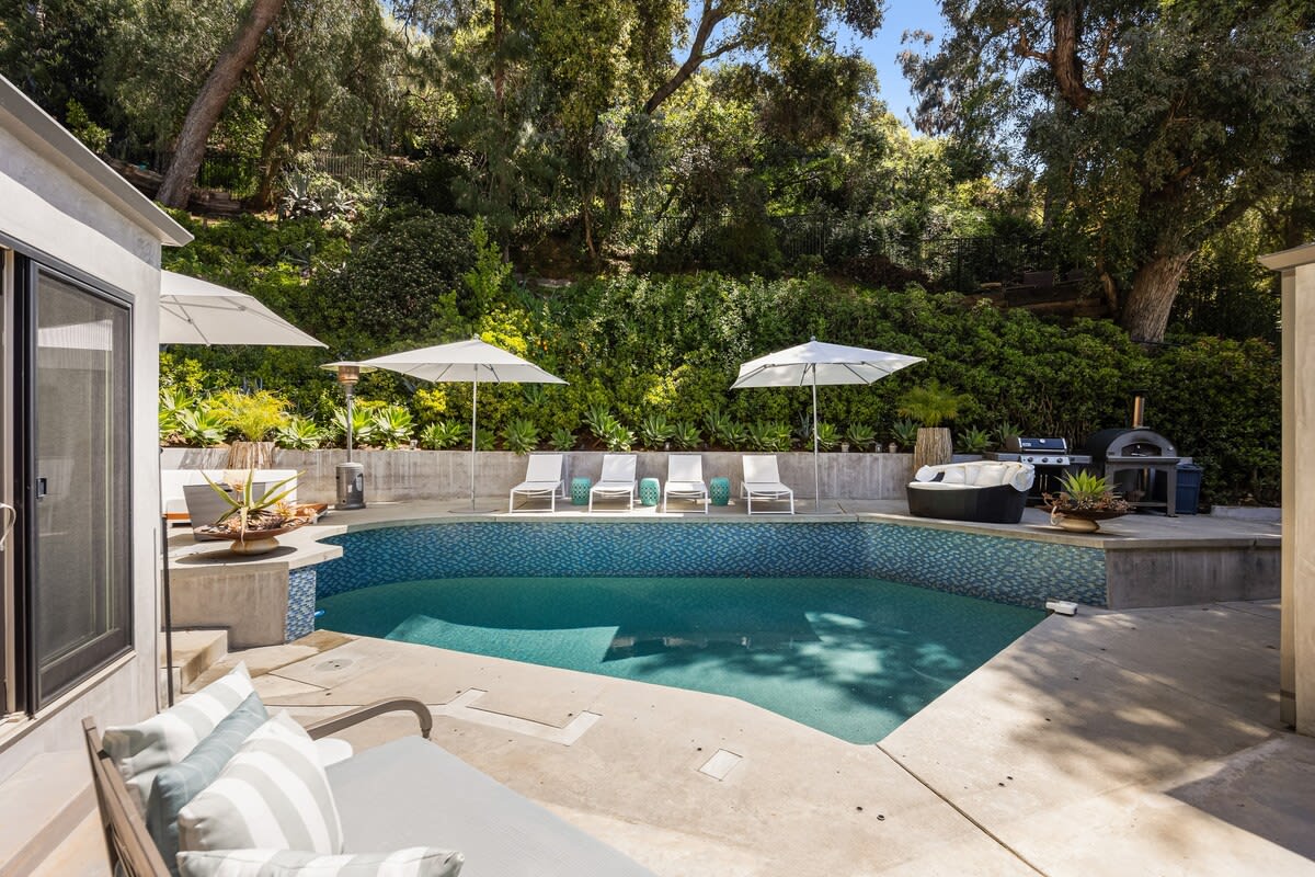 Lush green surroundings provide a picturesque backdrop to the outdoor retreat.