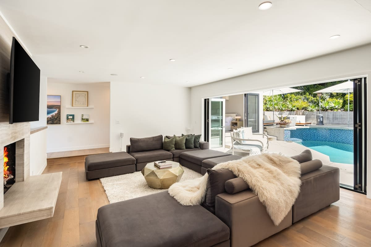 From the living area's sofa, catch your favorite shows on TV with direct access to the pool just steps away.