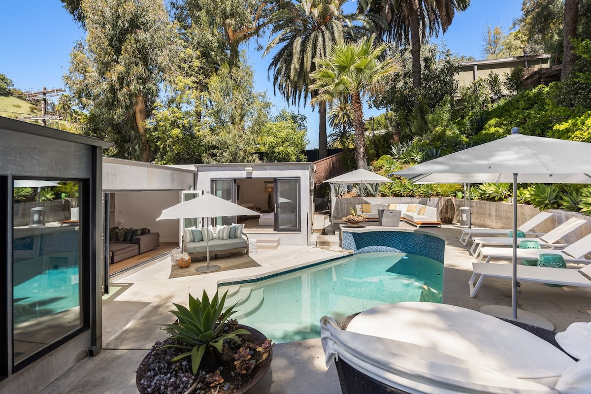 Lounge in luxury on sunbeds, soaking up the sun's warmth by the poolside.