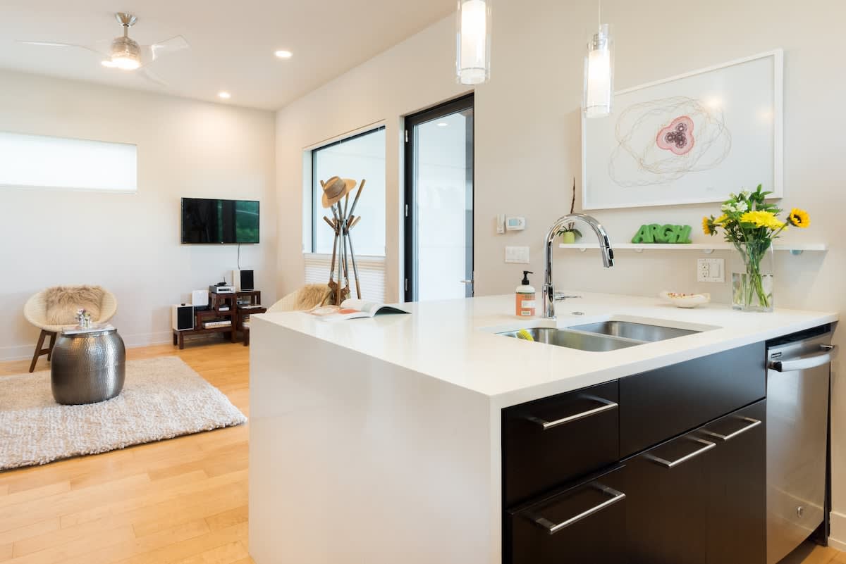 The kitchen looks out to living area with Smart TV and work desk