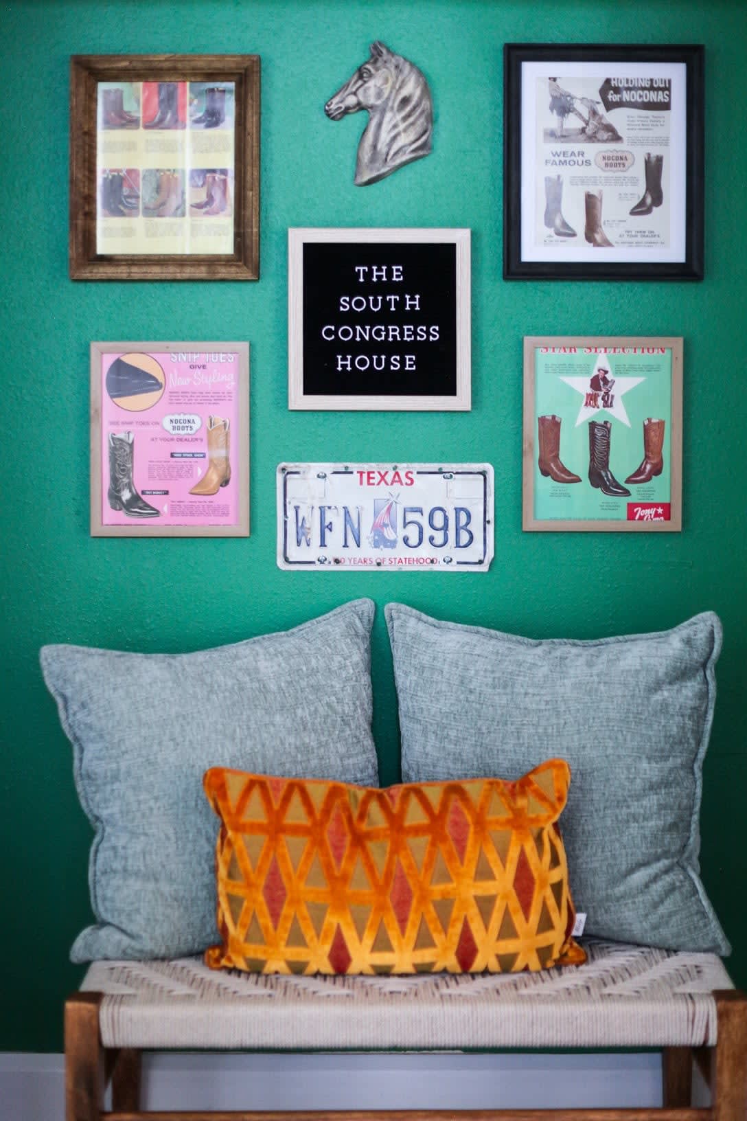 Gallery wall featuring vintage cowboy boot ads and relics of Texas past.