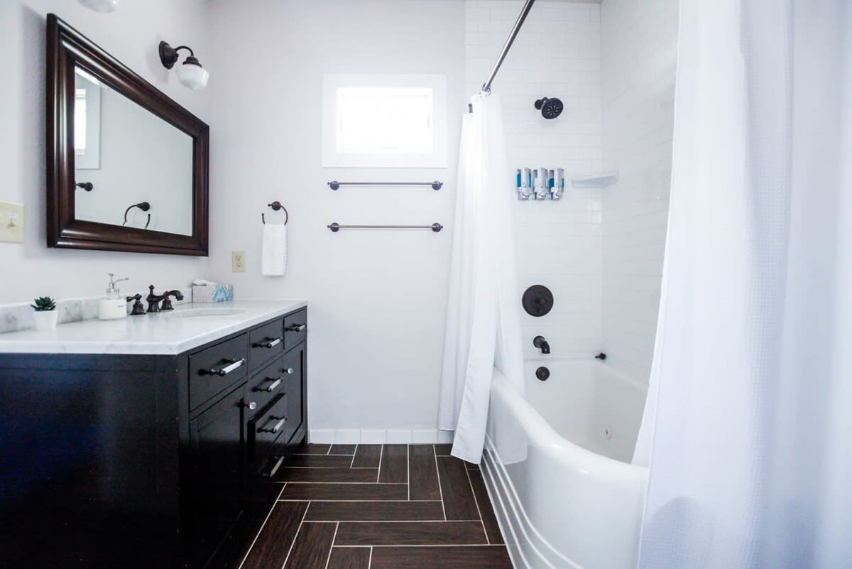 The master bathroom is very clean and modern but still sports vintage vibes with this beautiful tub.