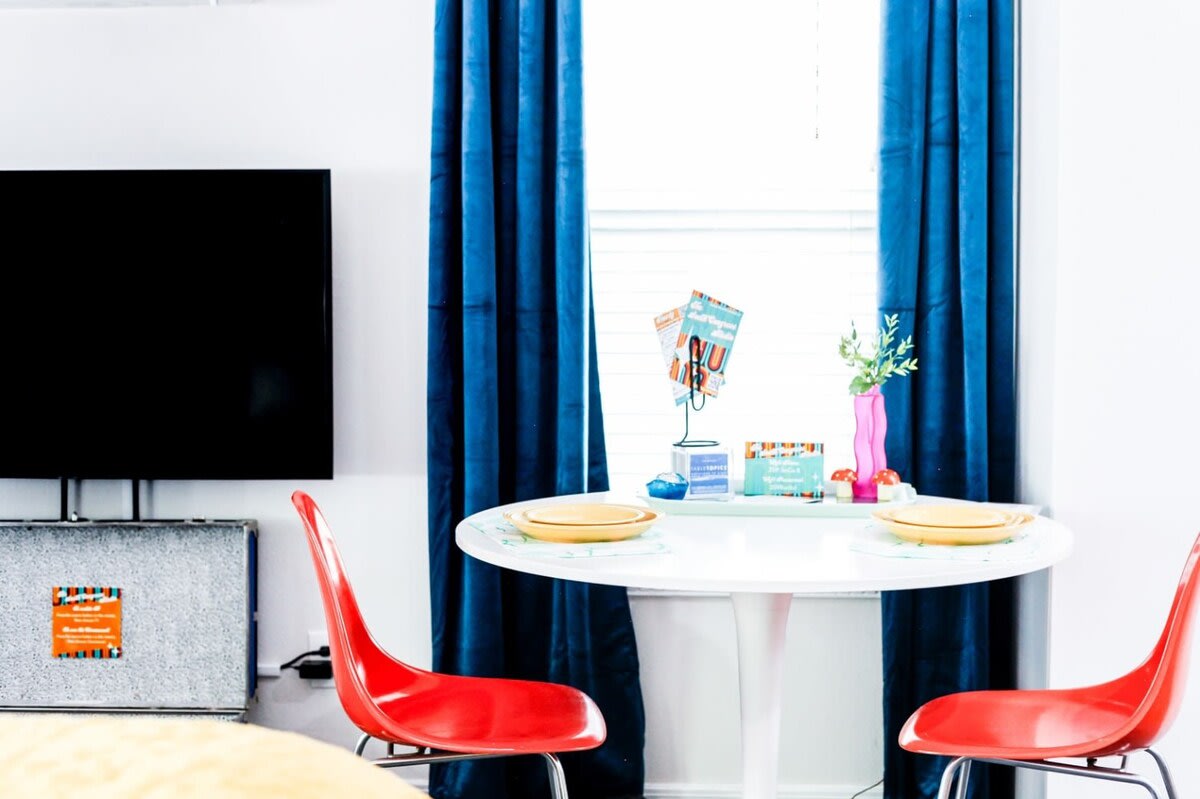 Comfortable, vintage Eames-style chairs add a bright pop in the dining corner.