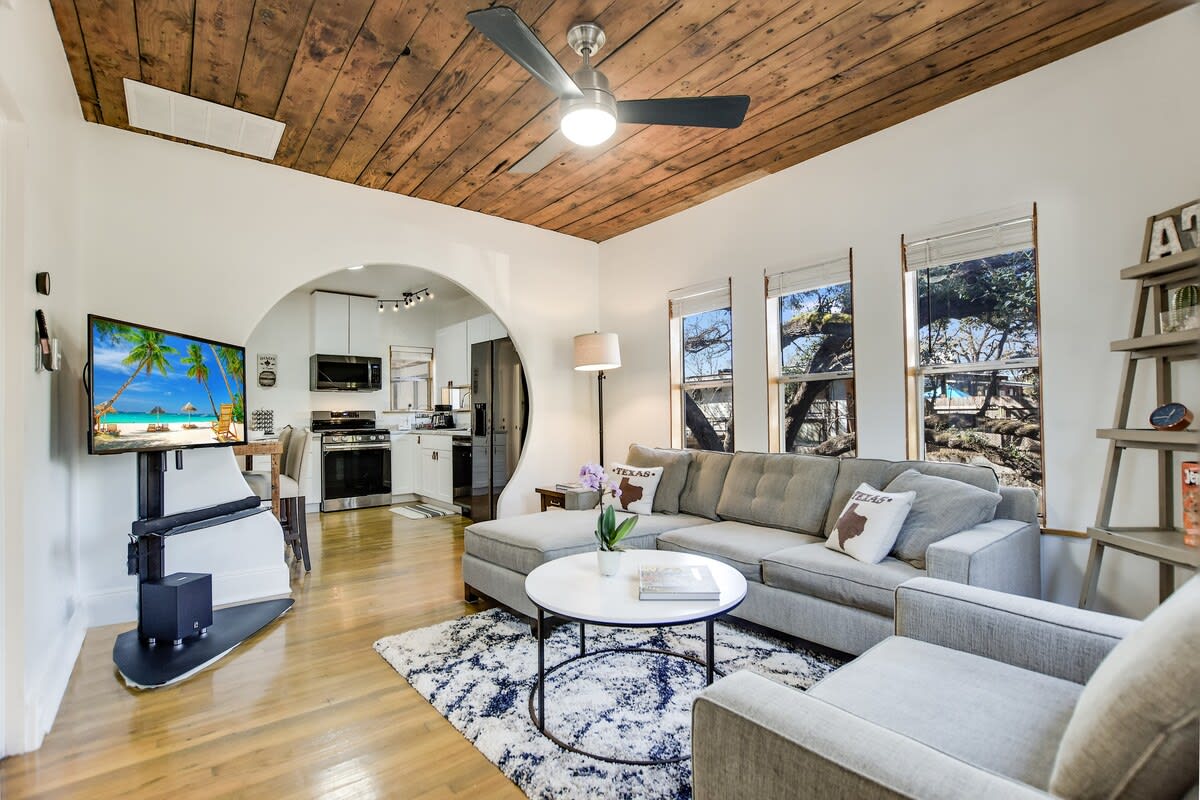 The living area offers lots of natural light and comfy furnishings. Guests can also enjoy the wooded views of the creekside.