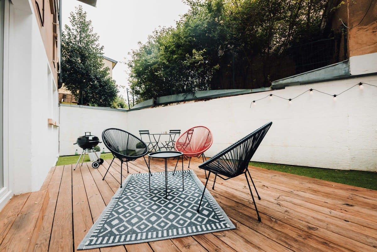 Charming outdoor deck with comfortable seating, perfect for enjoying the fresh air and relaxing in a private space.