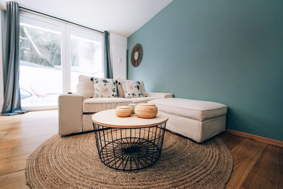 Comfortable and stylish living room with ample natural light, perfect for unwinding after a day of sightseeing.